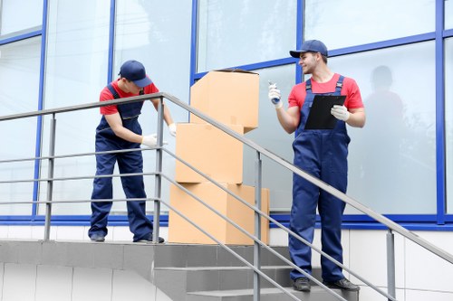 Removal team working around a modern Canary Wharf apartment building