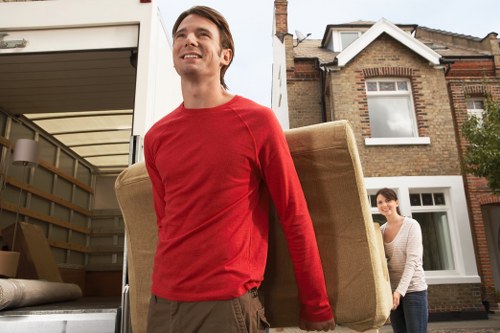 Local movers handling a load near Canary Wharf offices and towers