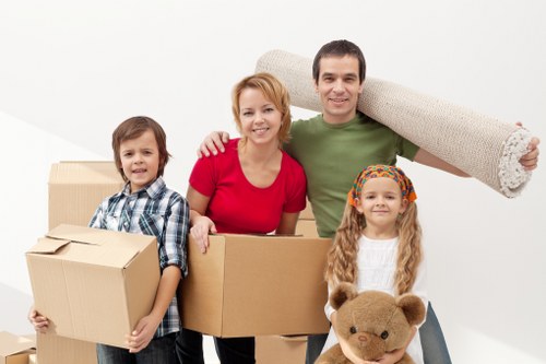 Removal team handling furniture move near Canary Wharf apartment buildings
