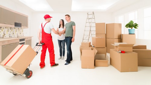 Local moving team organising boxes in a Canary Wharf residential building