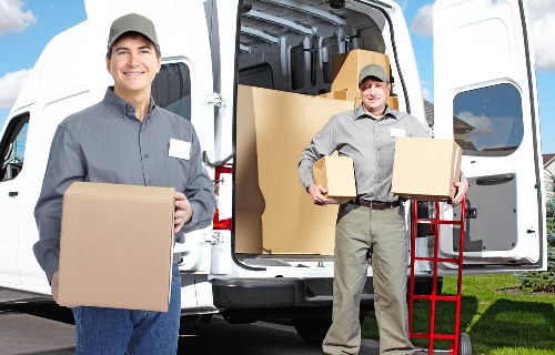 Moving crew handling items in a modern Canary Wharf high-rise